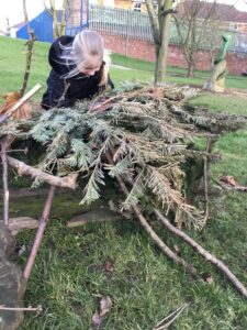 Child building a den at Thornhill Primary School