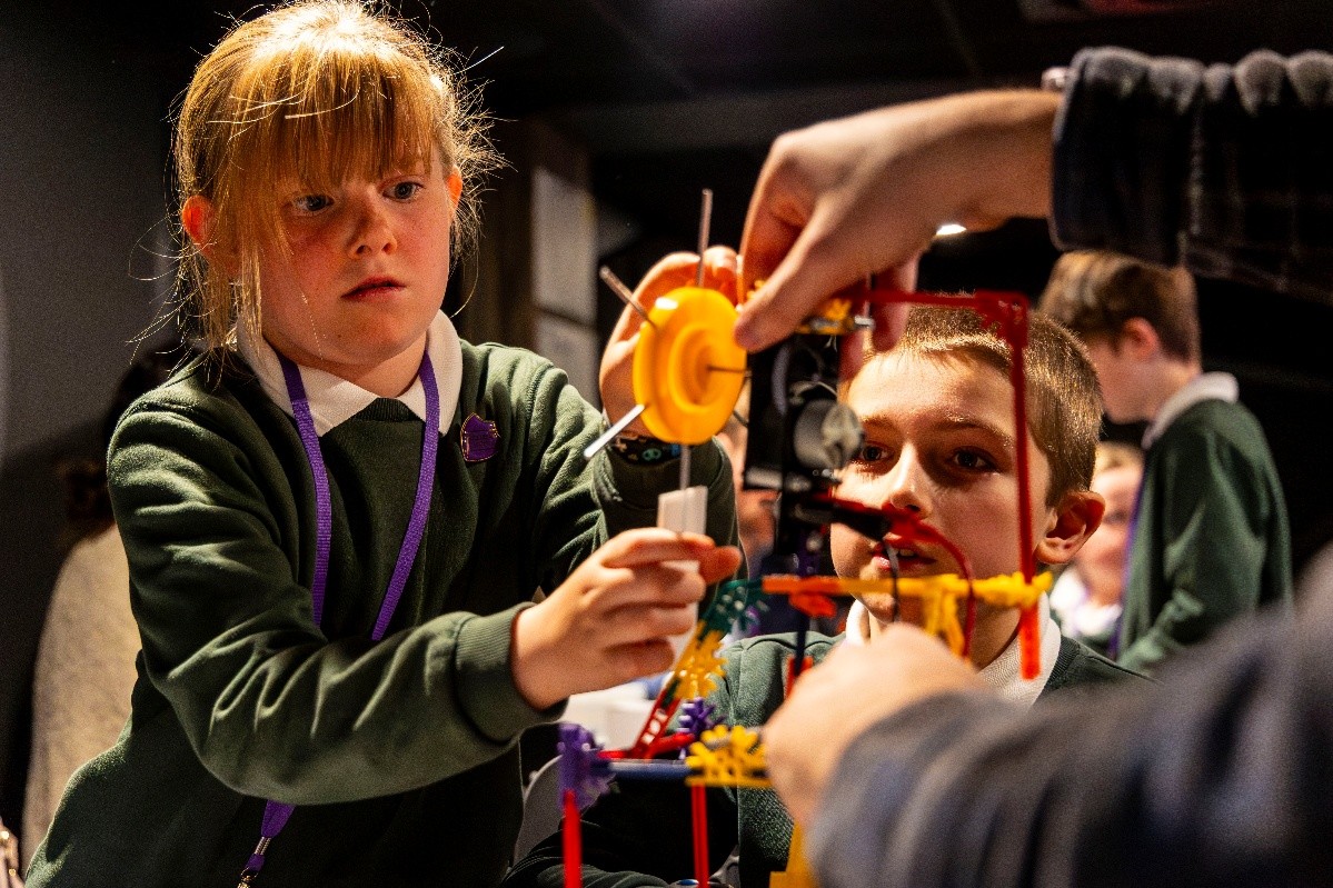 Child creating model wind turbine using OASES' Supergrid kit.